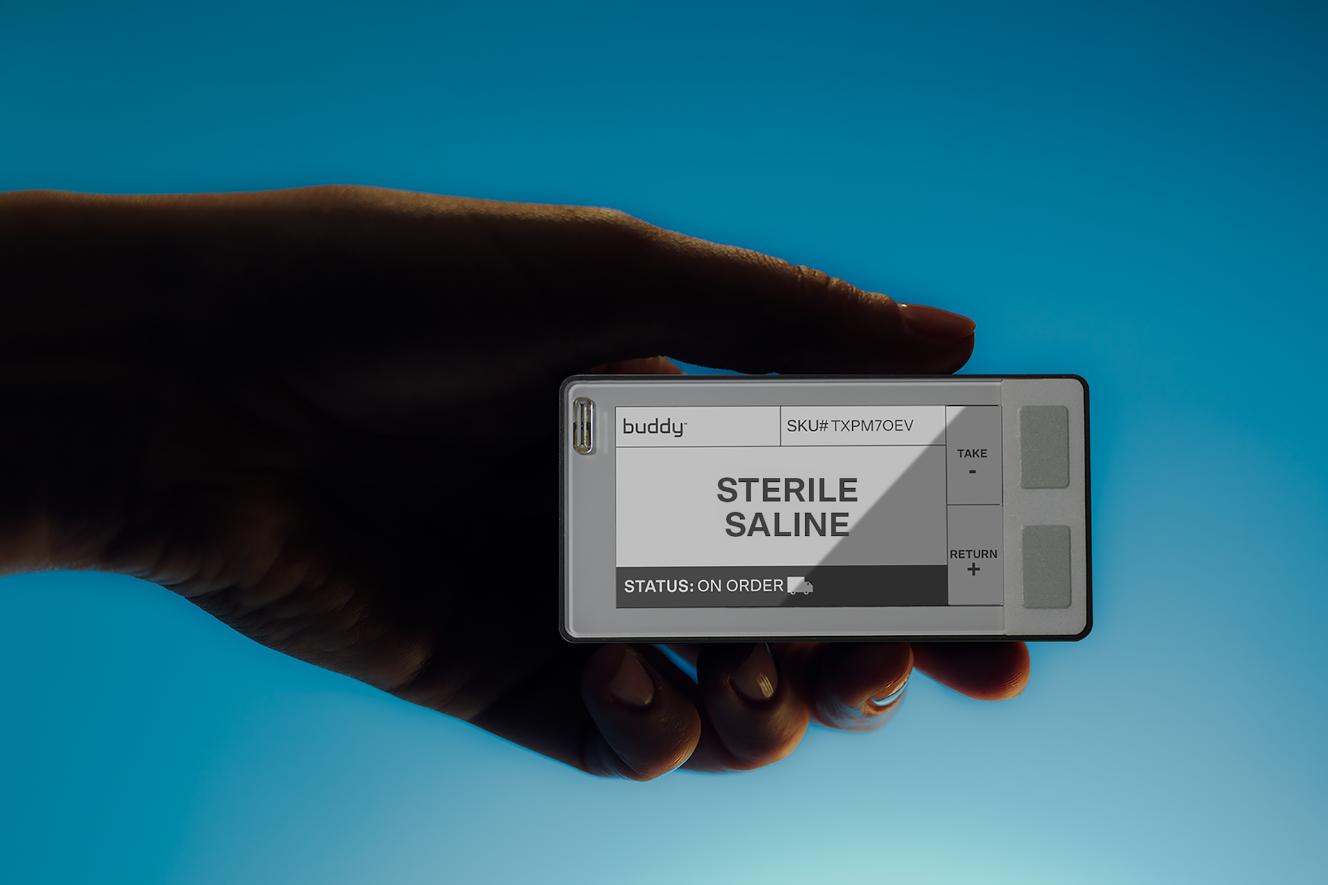 Hand holding Buddy device showing Sterile Saline status